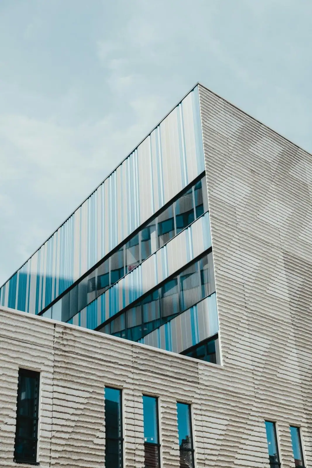Modern commercial building with blue glass facade, ideal for urban market analysis.