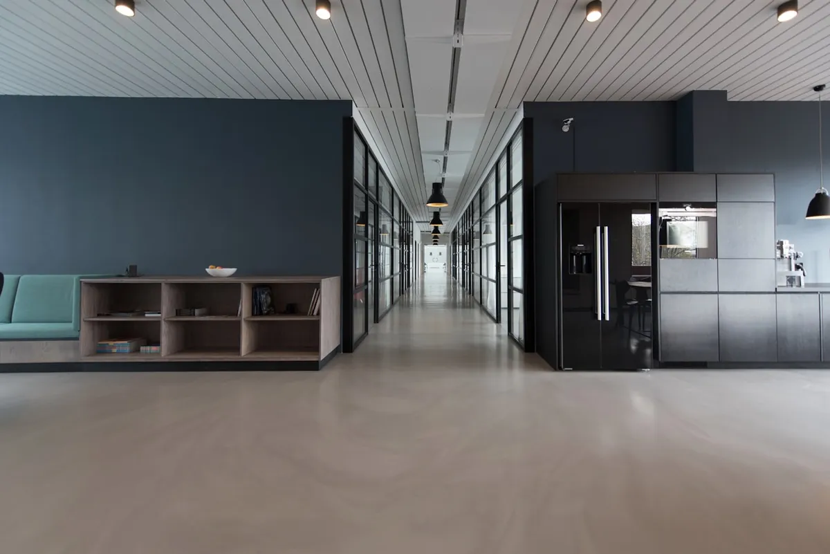 Warm office interior with a timber table and generous daylight