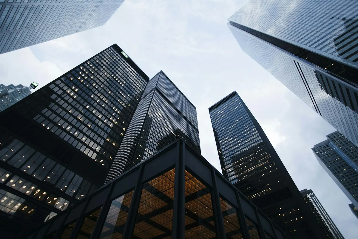 Glass commercial building exterior against a pale sky
