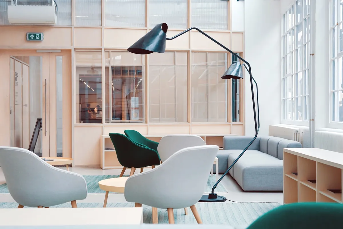 Quiet commercial workspace with a long conference table and windows