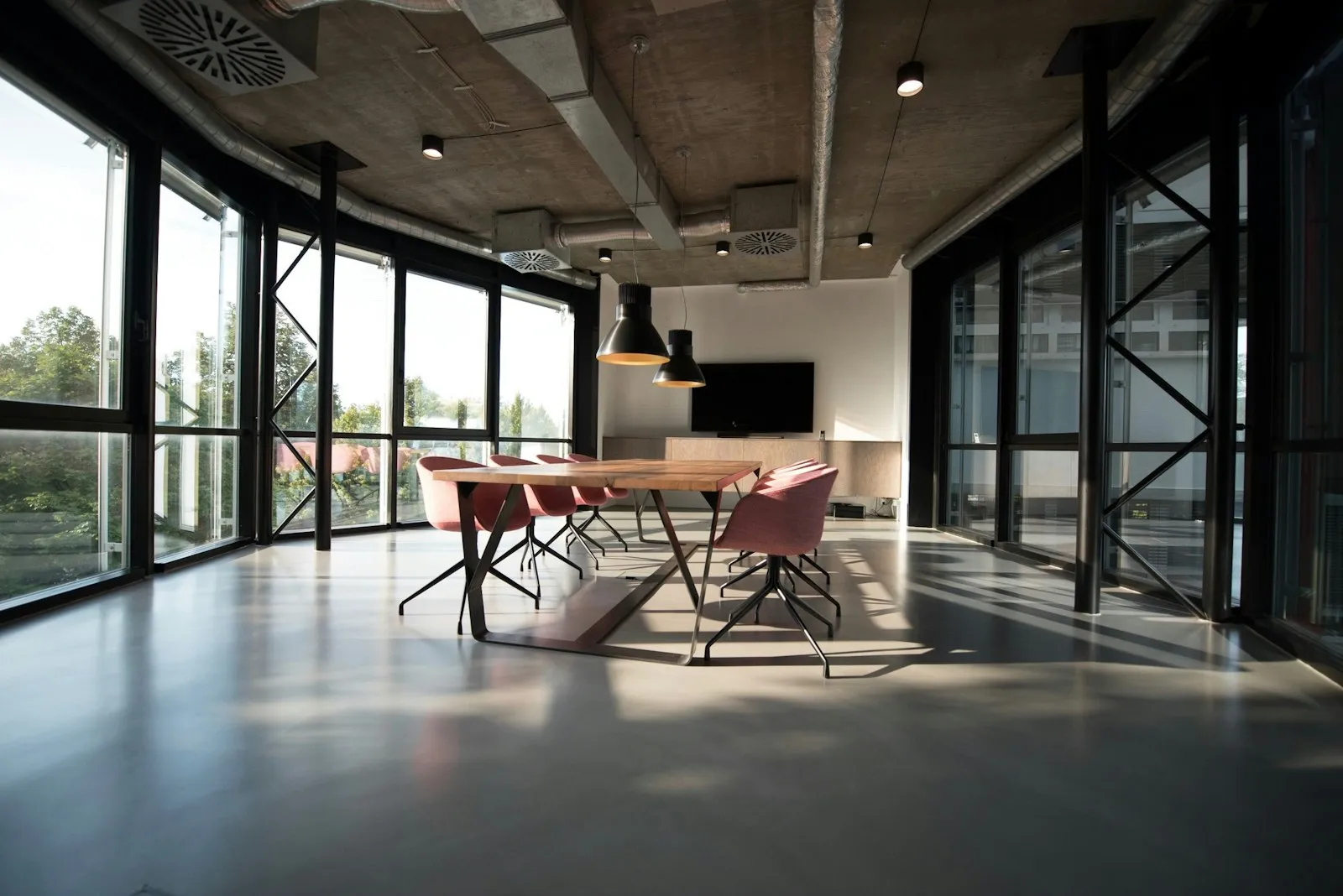 Warm commercial office interior with glass walls, timber details, and soft daylight