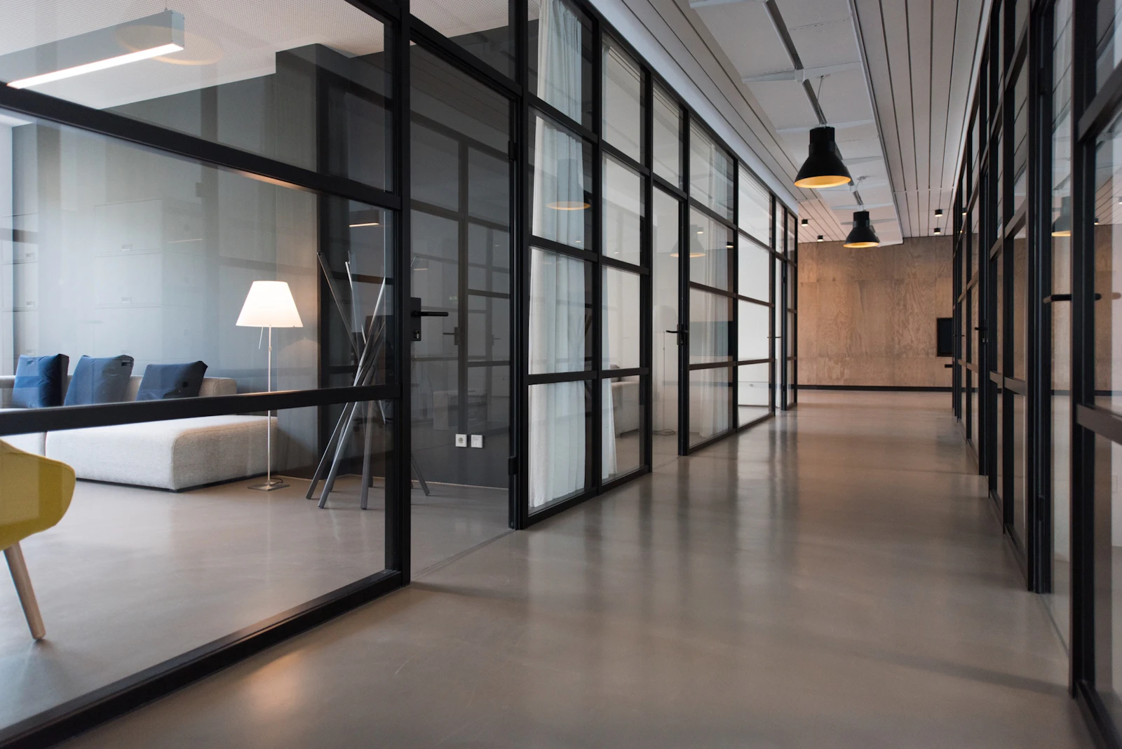 Executive office with warm daylight, wood table and lounge seating